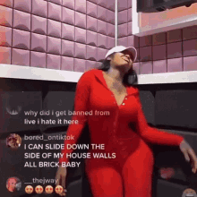 Woman in Red Outfit Dancing in Front of Brick Wall