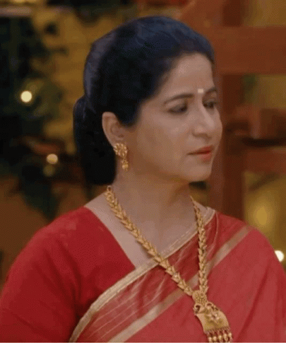 Woman in Red Saree Gold Jewelry Looking Side