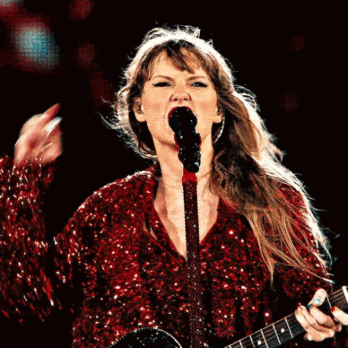 Woman in Red Sequined Dress Singing Microphone Guitar