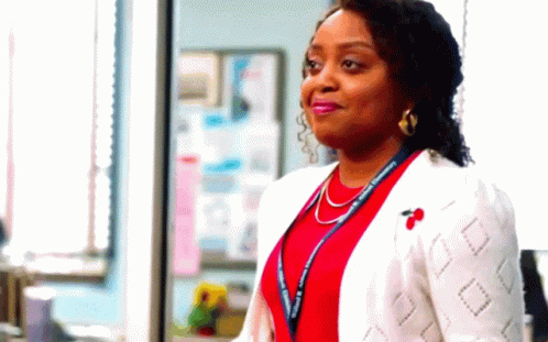 Woman In Red Shirt And White Jacket Standing GIF
