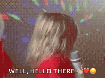 Woman In Red Shirt Dancing At Microphone Saying Well Hello There GIF
