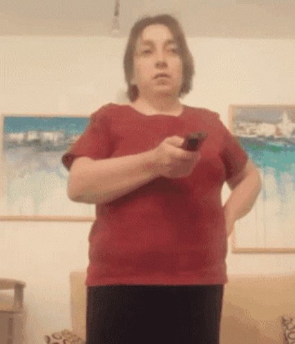 Woman in Red Shirt Holding Remote Control