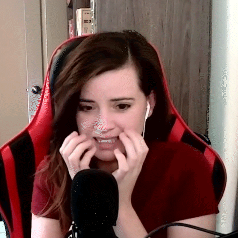 Woman In Red Shirt Making Funny Face At Microphone GIF