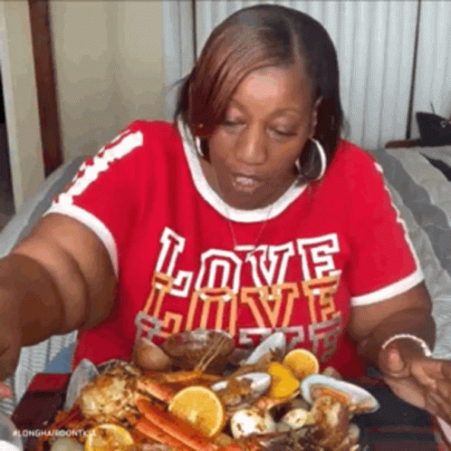 Woman In Red Shirt Saying Love Eating Seafood