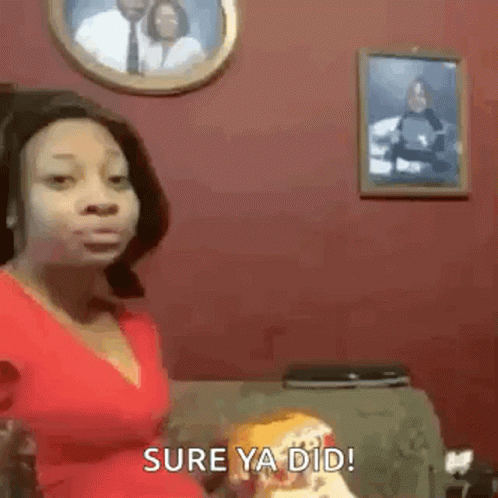 Woman In Red Shirt Sitting On Couch In Front Of Couple Picture GIF