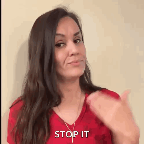 Woman in Red Shirt Thumbs Up Saying Stop It