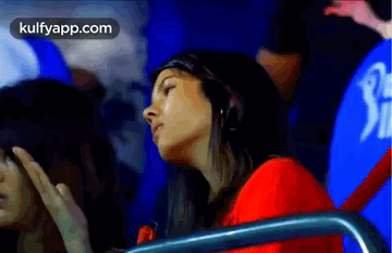 Woman in Red Shirt Watching Cricket