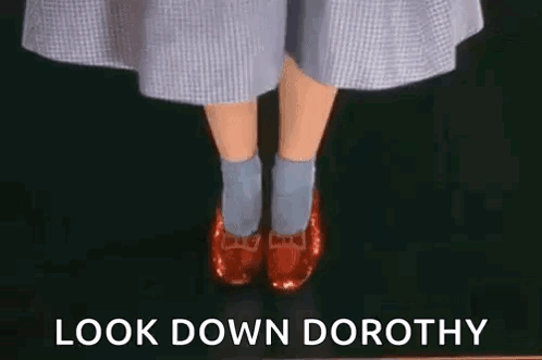Woman in Red Shoes and Blue Socks Says Look Down Dorothy
