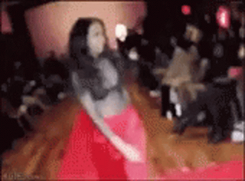 Woman in Red Skirt Dancing for Crowd