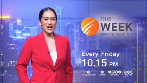 Woman in Red Suit in Front of This Week Wall