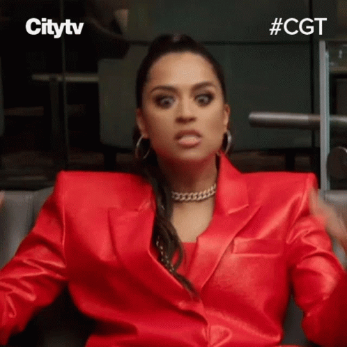 Woman In Red Suit Making Face GIF