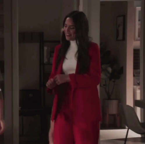 Woman in Red Suit Next to Woman in White Shirt