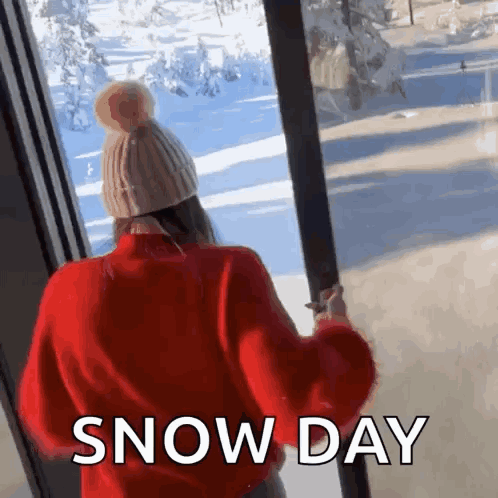 Woman in Red Sweater and Hat Looking Out Window