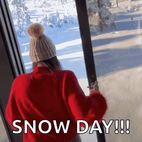 Woman in Red Sweater and Hat Looking Out Window