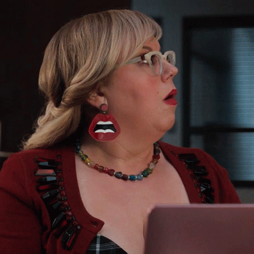 Woman in Red Sweater and Lip Earring Looking at Laptop