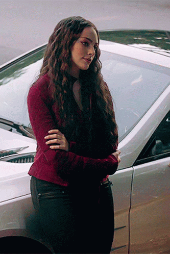 Woman in Red Sweater Beside Silver Car