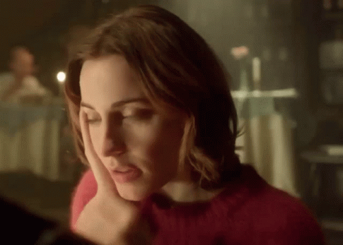 Woman In Red Sweater Looking Down GIF