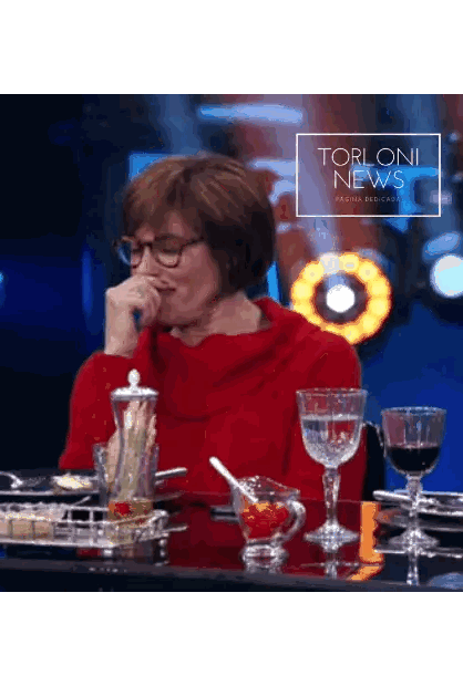Woman In Red Sweater Sitting At Table