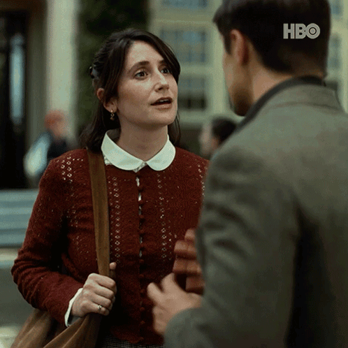 Woman In Red Sweater Talking To Man In HBO Suit GIF