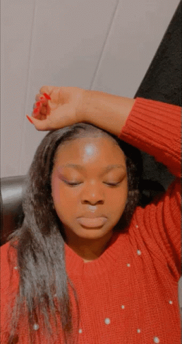 Woman In Red Sweater With Pearls Hand To Forehead GIF