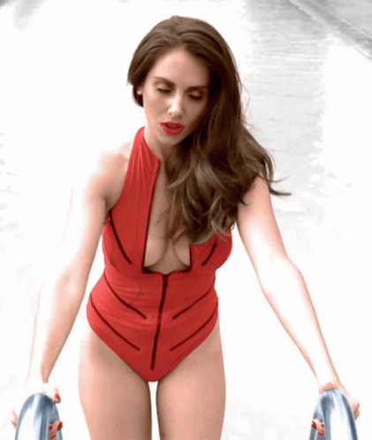 Woman In Red Swimsuit With Zipper Walking Down Sidewalk GIF