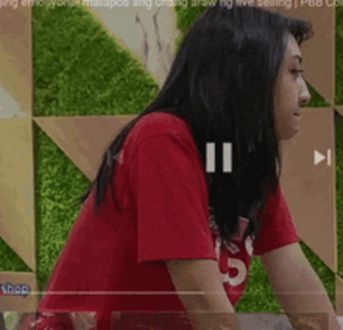 Woman In Red T-Shirt In Front Of Green Wall GIF