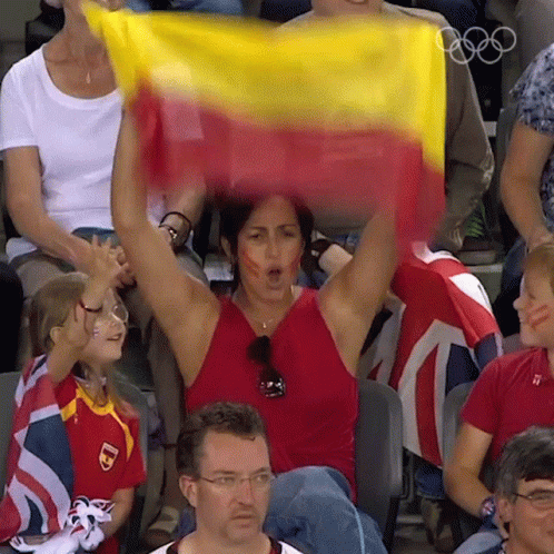 Woman in Red Tank Top Holding Yellow and Red Flag