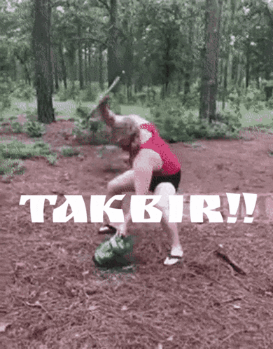 Woman In Red Tank Top Standing In Woods With Takbir GIF