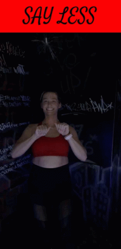 Woman In Red Top And Black Shorts With Say Less Sign GIF