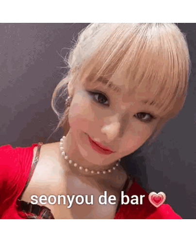 Woman in Red Top and Pearl Necklace Seonyou de Bar