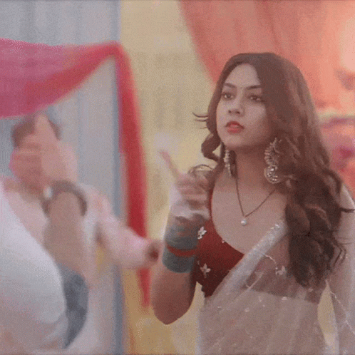Woman In Red Top And White Saree Pointing GIF