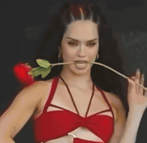 Woman in Red Top with Rose in Mouth