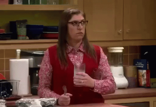 Woman in Red Vest Holding Milk and Fork