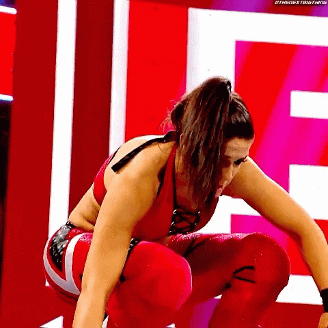 Woman in Red Wrestling Outfit Squatting