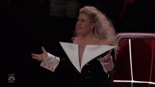 Woman in Revealing White Jacket at Microphone