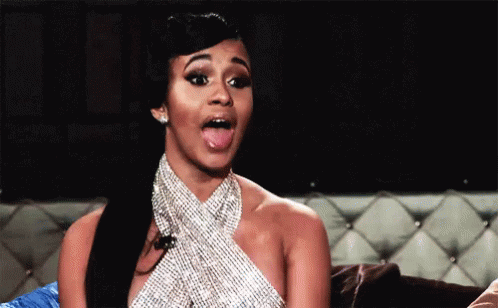 Woman In Rhinestone Dress Sticking Tongue Out On Couch GIF