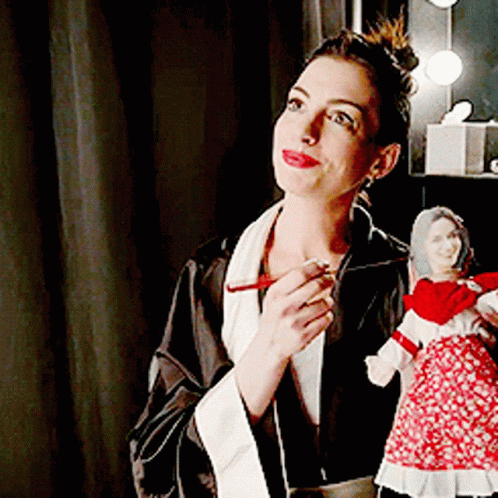 Woman in Robe Holding Doll