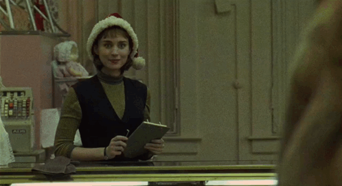 Woman in Santa Hat Looking at Herself