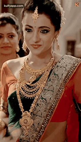 Woman in Saree and Gold Jewelry Smiling
