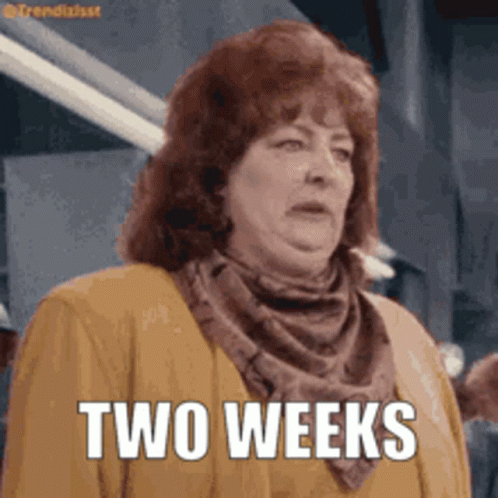 Woman in Scarf and Jacket Saying Two Weeks