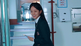Woman in School Uniform Walking Down Stairs With Cell Phone
