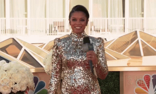 Woman in Sequined Dress by Golden Globe Sign