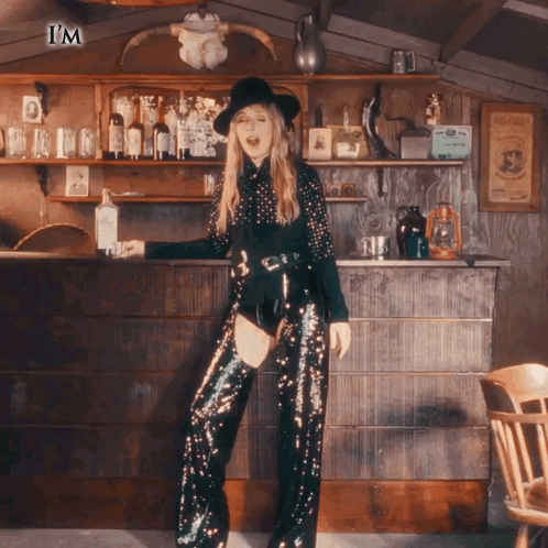 Woman In Sequined Pants And Hat At Bar Saying I'm GIF