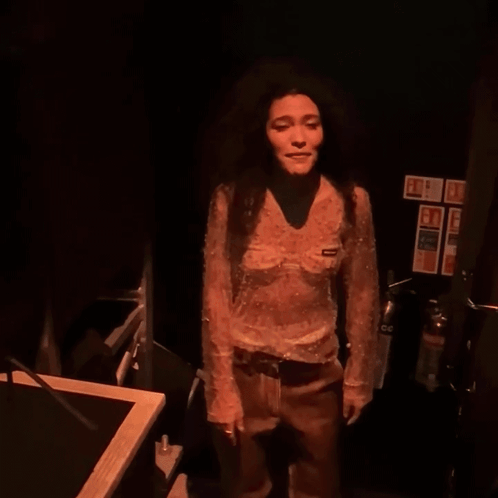 Woman In Sheer Top And Brown Pants Dancing GIF