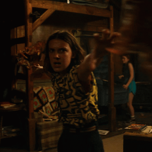 Woman in Shirt Saying A in Dark Room