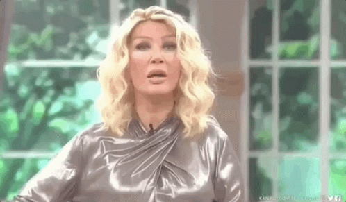 Woman In Silver Dress Making Funny Face GIF