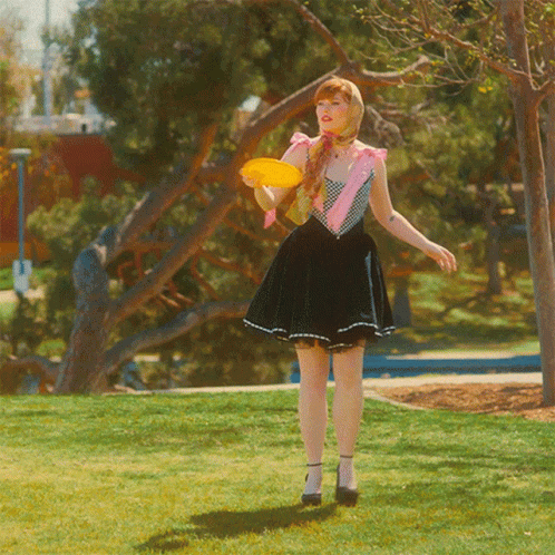 Woman In Skirt Holding Frisbee GIF