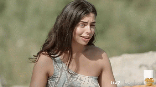 Woman in Snake Print Top in Front of ITV2 Love Island Sign