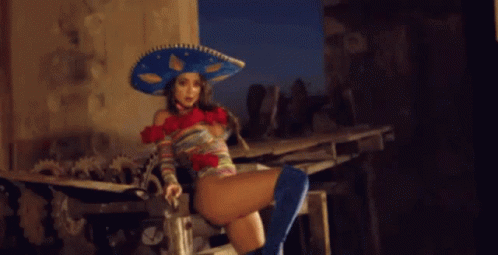 Woman in Sombrero and Blue Boots Sitting on Bench