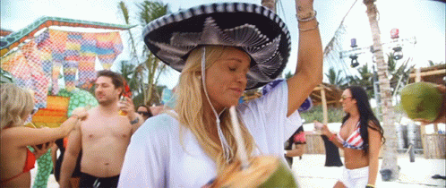 Woman in Sombrero Holding Coconut